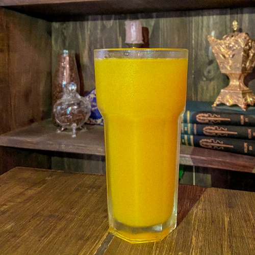 Um copo com líquido laranja